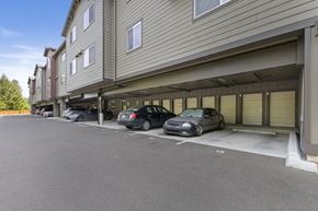 Olympia apartment for rent - A parking lot with cars parked in front of a building.