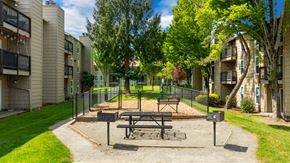 Everett apartment for rent - A picnic table is in the middle of a playground in a residential area.