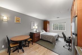 Bellevue apartment for rent - a bedroom with a bed and a desk and a table