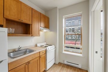 Seattle apartment for rent - A kitchen with wooden cabinets and a white fridge.