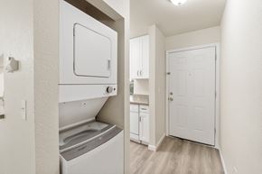 Bellevue apartment for rent - a renovated kitchen with white cabinets and a white door and a washer and dry