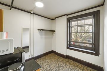 Seattle apartment for rent - A kitchen with a microwave, oven, and a window.