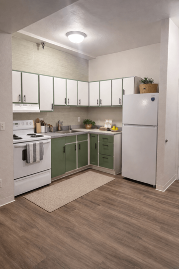 Olympia apartment for rent - A kitchen with white cabinets and a white refrigerator.