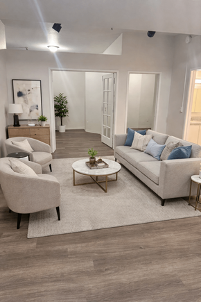 Olympia apartment for rent - A living room with a grey sofa, a white armchair, a wooden coffee table, and a rug.