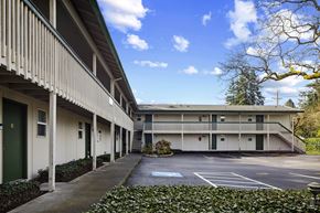 Lakewood apartment for rent - A long building with a green door and a white wall.