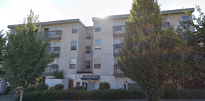 Seattle apartment for rent - Apartment building with balconies and trees in front.