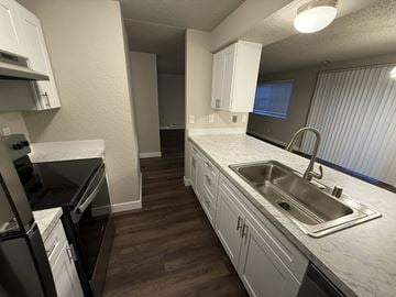 Tacoma apartment for rent - A kitchen with white cabinets and a stainless steel sink.