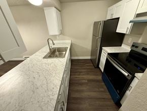 Tacoma apartment for rent - A kitchen with a sink, refrigerator, and oven.