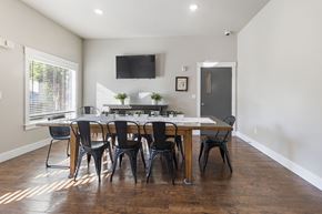 Tumwater apartment for rent - Meeting room with large table and chairs and tv mounted on wall