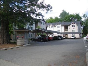 Shelton apartment for rent - a parking lot with cars parked in front of a building