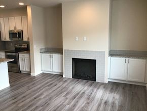 Fife apartment for rent - a renovated living room with white cabinets and a fireplace
