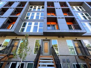 Seattle apartment for rent - A tall building with a tree in front of it.