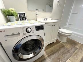 Lakewood apartment for rent - A washing machine is on top of a washbasin in a bathroom.