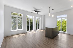 Lacey apartment for rent - A spacious room with a ceiling fan and sliding glass doors at The Hub Apartments, Washington 98503