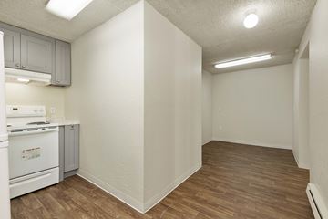 Seattle apartment for rent - A kitchen with a white stove and wooden floors.