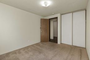 Seattle apartment for rent - A room with a carpeted floor and a wooden door.