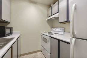 Seattle apartment for rent - A kitchen with a white refrigerator, a white oven, and a white microwave.