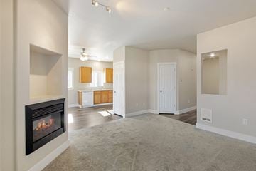 Tumwater apartment for rent - A living room with a fireplace and a carpet on the floor.