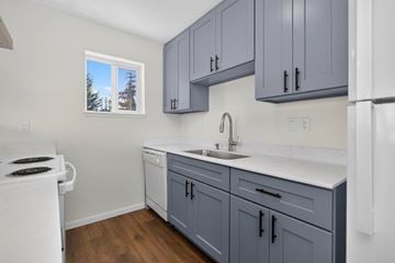 Everett apartment for rent - A kitchen with a white stove and a white refrigerator.