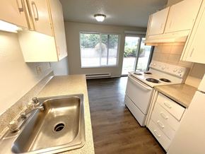 Lakewood apartment for rent - A kitchen with white appliances and a stainless steel sink.