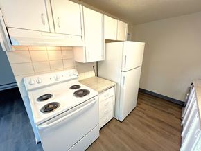 Lakewood apartment for rent - A white stove and refrigerator in a small kitchen.