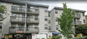 Seattle apartment for rent - Apartment building with a tree in front.
