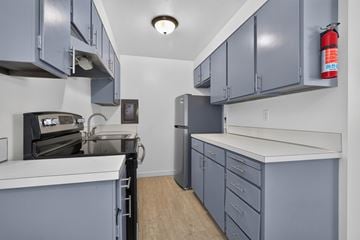 Lynnwood apartment for rent - A kitchen with grey cabinets and a white counter.