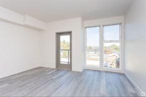 Seattle apartment for rent - A room with a grey floor and white walls has a sliding glass door.