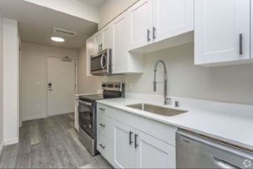 Seattle apartment for rent - A kitchen with white cabinets and stainless steel appliances.