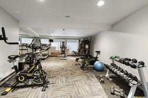 Bellevue apartment for rent - a gym with weights and bikes in the corner of a room