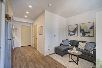 Lacey apartment for rent - A living room with a couch, coffee table, and two paintings on the wall.