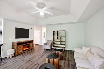 East Moriches apartment for rent - A living room with a white couch and a television.
