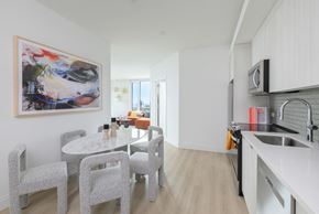 Brooklyn apartment for rent - a kitchen and dining room with a white table and chairs