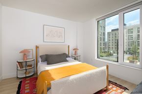 Brooklyn apartment for rent - a bedroom with a bed and a large window