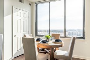 North Bethesda apartment for rent - A dining room with a table set for two and a view of the city.