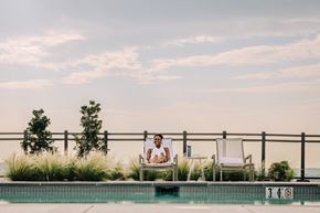 Washington apartment for rent - a man sitting in a chair next to a pool