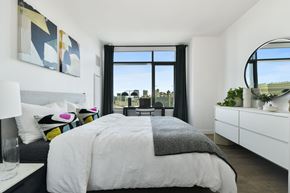 Cambridge apartment for rent - A bedroom with a large bed and a view of the city.