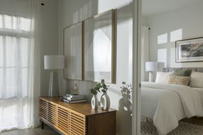 North Bethesda apartment for rent - A bedroom with a bed, nightstand, and a large mirror.