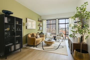 North Bethesda apartment for rent - A living room with a yellow chair and a large window.