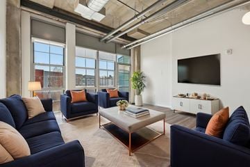 Everett apartment for rent - A living room with blue couches and a large window.