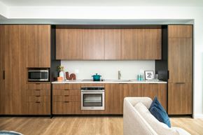 Cambridge apartment for rent - a kitchen with wooden cabinets and a sink and a microwave