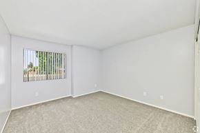 Riverside apartment for rent - A room with a window and a carpeted floor.