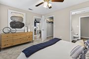 Hattiesburg apartment for rent - A bedroom with a large bed and a wooden dresser.