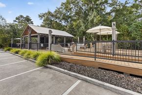 Mobile apartment for rent - A parking lot with a gazebo and a fence.