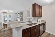 Ocean Springs apartment for rent - A kitchen with brown cabinets and a granite countertop.