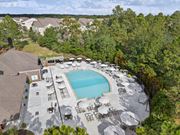 Mobile apartment for rent - An aerial view of a swimming pool surrounded by lounge chairs and umbrellas.