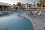 Oxford apartment for rent - A large outdoor swimming pool with sun loungers and a building in the background. at The Azul Apartment Homes, Oxford, Mississippi