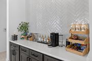 Santa Rosa Beach apartment for rent - A kitchen counter with a black coffee maker and a wooden crate filled with snacks at Saltaire Apartment Homes in Santa Rosa Beach, Florida