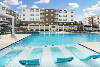A large swimming pool with a building in the background