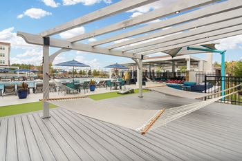 A deck with hammocks and umbrellas at the marina at watermark